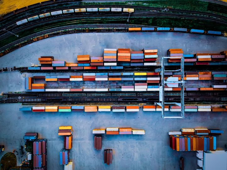 Top view of freight containers at railway logistics hub Top view of colorful freight containers arranged at a railway station used for intermodal cargo transport and logistics distribution