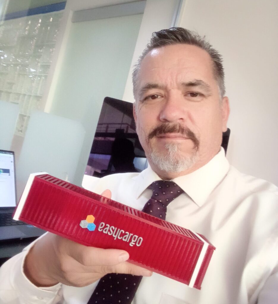 Professor Luis Cortés Domínguez from Universidad Politécnica de Aguascalientes holding the Container Challenge Puzzle, used to&nbsp;demonstrate practical load planning challenges.